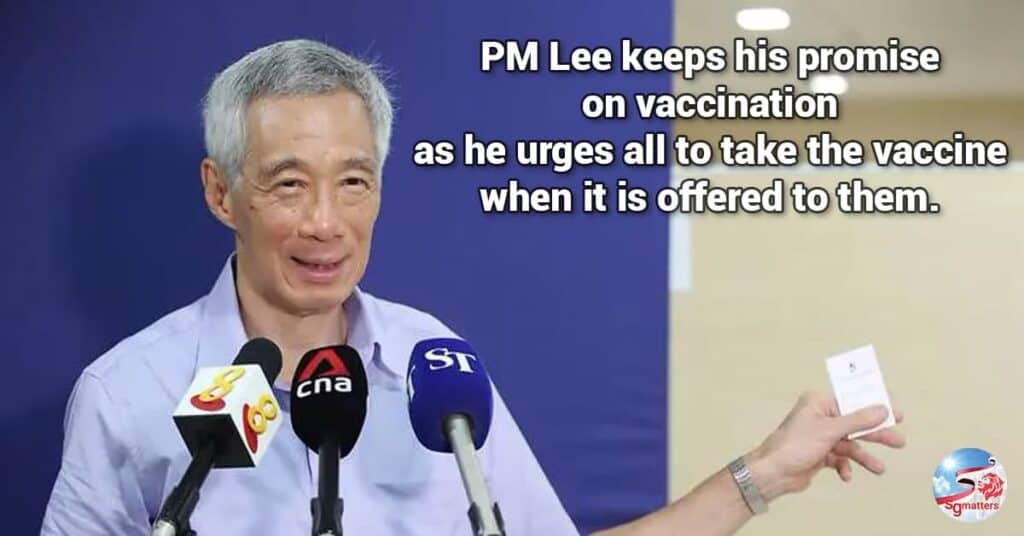 Mr Lee shows reporters the appointment card for his second jab for the COVID-19 vaccine after receiving his first dose on Jan 8, 2021. (Photo: Ministry of Communications and Information)